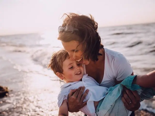 Woman on beach with little boy